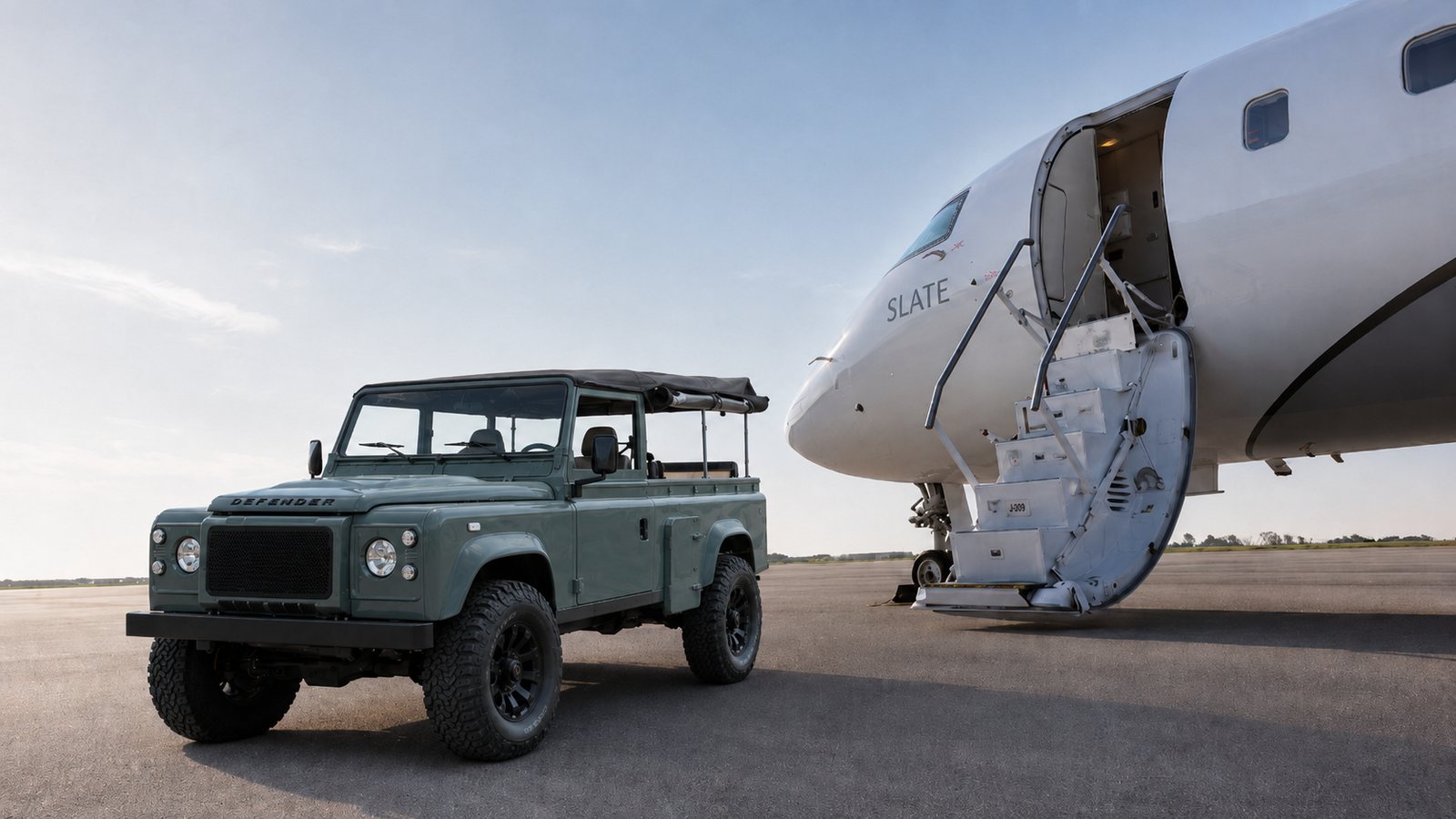 Slate Aviation jet beside an East End Reserve Land Rover Defender